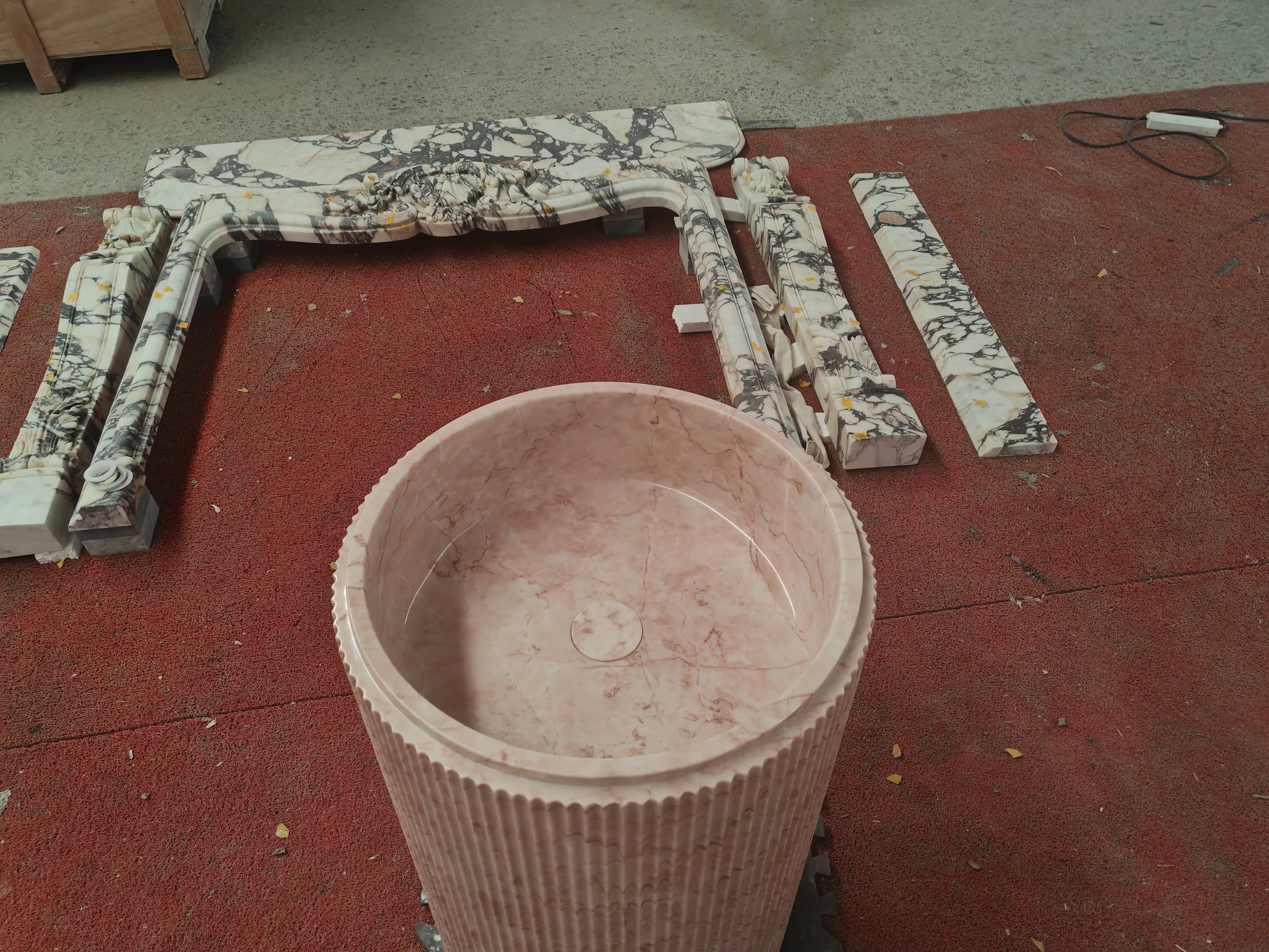 Reference photo — pink marble pedestal sink in workshop